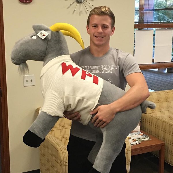 Gompei the goat in his WPI sweater as a giant stuffed animal
